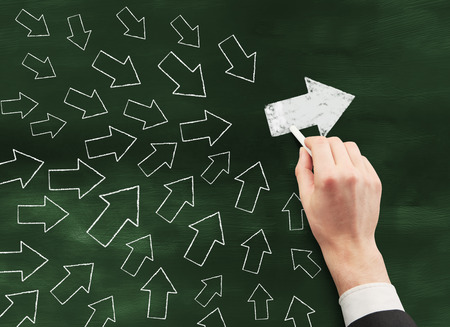 Hand drawing arrows on chalkboard. Leader conceptの写真素材