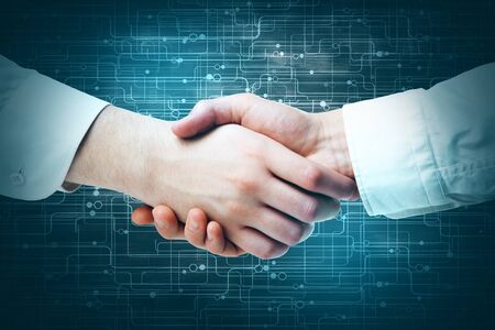 Side view and close up of handshake on abstract circuit background. Teamwork concept
