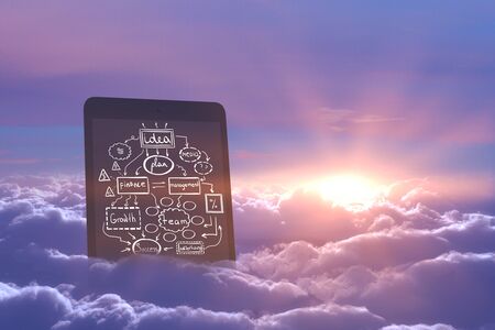 Abstract image of tablet with business sketch in sky with clouds and sunset. Imagination concept