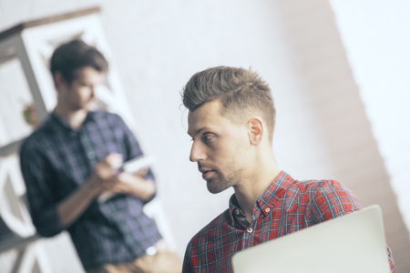 Thoughtful european man at workplaceの写真素材