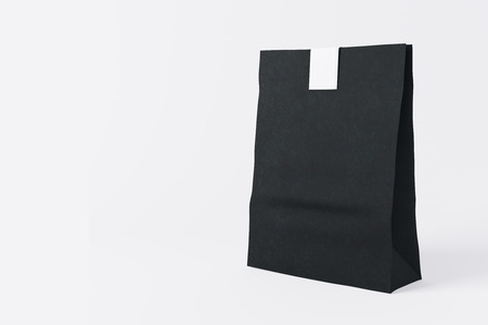 Sealed black paper lunch bag on light background. Container concept. Mock up, 3D Renderingの写真素材