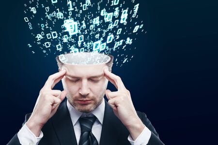 Abstract image of pensive young businessman with abstract binary code stream on blue background. Programming conceptの写真素材