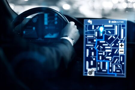 Close of man driving car with abstract digital hologram for tracking taxi car on map. Future and innovation concept. 3D Renderingの写真素材