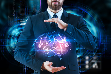Businessman holding abstract polygonal brain on tech background. Artificial intelligence and robotics concept. Double exposure の写真素材