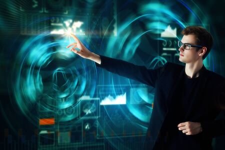 Handsome european businessman using abstract digital business interface. Technology and innovation...