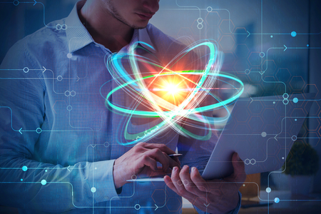Businessman using laptop with abstract atom interface. Technology and science concept. Double exposure の写真素材
