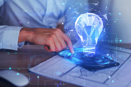 Businessman using digital tablet with glowing blue polygonal lamp projection at blurry workplace. Success and network concept. Double exposure の写真素材