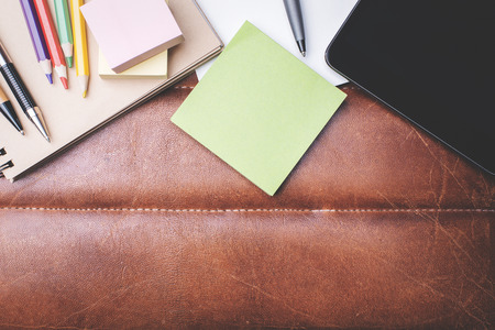 Top view of desktop with tablet and colorful supplies with copy spaceの写真素材