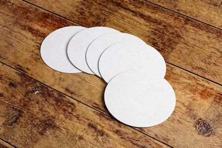 Top view and close up of round beer coaster on wooden counter. Mock up, 3D Rendering の写真素材