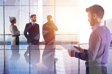 Businesspeople in abstract glass office interior with sunlight and city view. Meeting and deal concept. Double exposure の写真素材