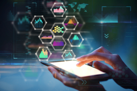 Hand using tablet with abstract glowing business hologram on blurry background. Network and future concept. Double exposure の写真素材