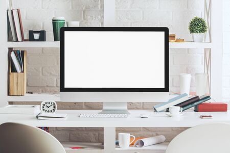 Close up of hipster desktop with blank white computer monitor, stationery items and other objects....