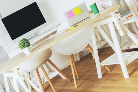 Modern interior with creative designer desktop, empty computer monitor and other items. Design and workspace concept. Mock up の写真素材