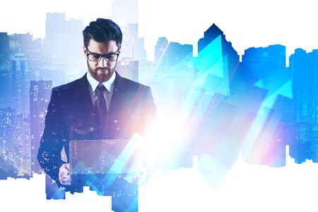 Businessman using laptop on abstract night city background with digital arrows. Finance and success concept. Double exposure の写真素材