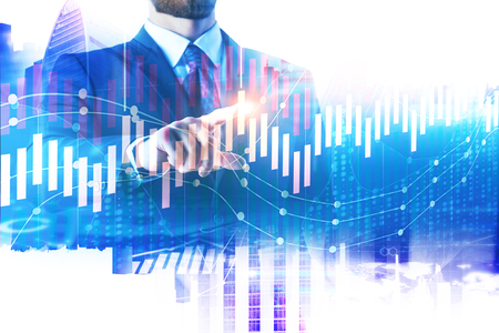 Investment and market concept. Businessman pointing at forex chart on abstract city office background. Double exposure の写真素材