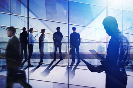 Meeting and partnership concept. Businesspeople in abstract iterior with city view. Double exposureの写真素材
