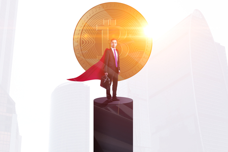 Businessman standing on pedestal with golden bitcoin, sunlight and city view. Leadership and investment concept. Double exposure の写真素材