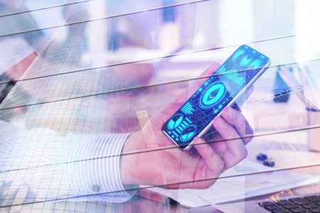 Side view of hand holding smartphone with ethereum app at workplace with city view. Cryptocurrency and trade concept. Double exposure の写真素材