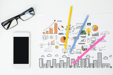 Top view of white office desk with blank smartphone, glasses, supplies and other items. Mock up の写真素材