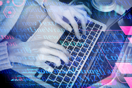 Programming, computing and software concept. Close up of hands using laptop on abstract background...