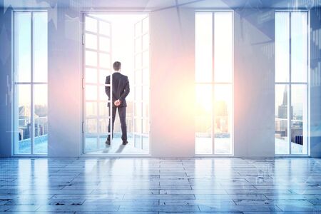 Businessman looking out of window in abstract city interior. Research and think concept. 3D Rendering の写真素材