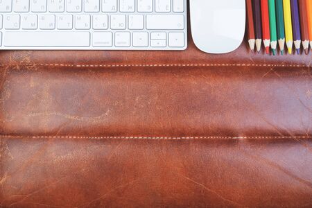 Top view of brown leather workspace with supplies, other items and copy space. Design and occupation concept. Mock up の写真素材