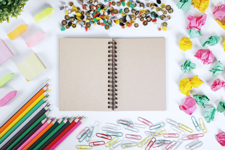 Close up of modern office desktop with blank notepad and other supplies. Above view. Mock up の写真素材