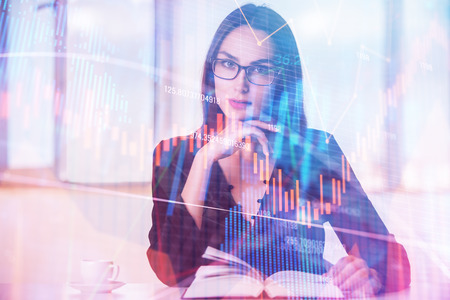 Portrait of beautiful young european businesswoman with forex chart. Investment, fund management and education concept. Double exposure の写真素材