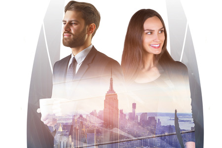 Attractive european businessman and woman standing on abstract city background. Teamwork, success and finance concept. Double exposure の写真素材