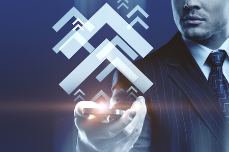 Male hand holding cellphone with digital media arrows. Technology and communication concept. Double exposure の写真素材