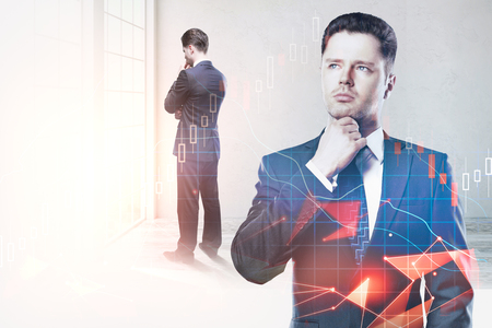 Thoughtful young businessman standing in blurry office interior with forex chart. Research, analysis and trade concept. Double exposure の写真素材
