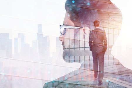 Businessman walking on abstract city background with copy space. Double exposureの写真素材