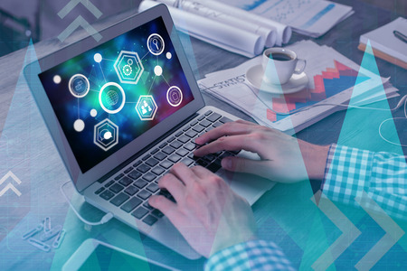 Hands using laptop with creative digital forex graph at workplace. Accounting and stock concept. Double exposure の写真素材