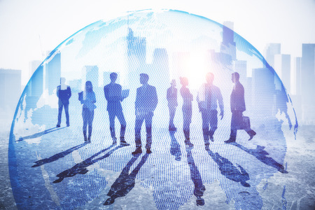 Businesspeople on abstract city background with globe and daylight. Global business and employment...