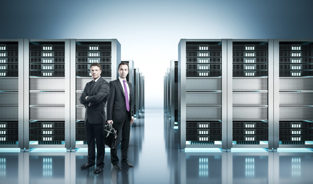 Two handsome young european businessmen standing in shiny server room. 3D Rendering