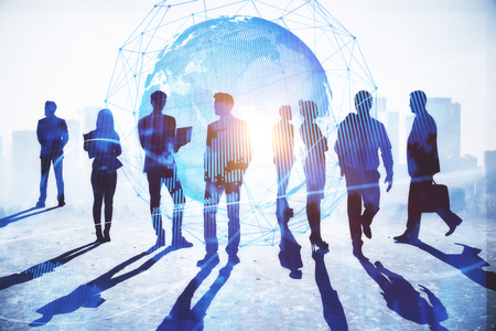 Businesspeople on abstract city background with globe and daylight. Global business and success concept. Double exposureの写真素材