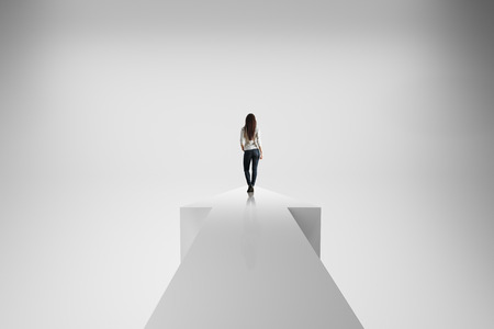 Back view of young woman standing on arrow on abstract white background. Growth and success concept. 3D Renderingの写真素材