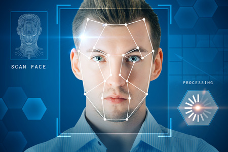 Portrait of attractive young businessman with facial recognition system. Authentication and privacy conceptの写真素材