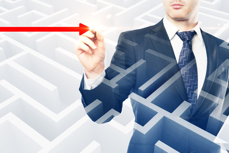 Businessman hand drawing red arrow way out on abstract maze background. Leadership and success concept. Double exposureの写真素材
