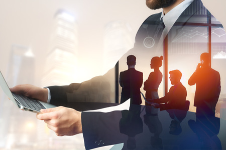 Abstract image of businessmen using laptop on abstract blurry background. Teamwork and meeting concept. Double exposureの写真素材