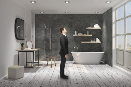 Side view of young businessman standing in modern bathroom interior. 3D Renderingの写真素材