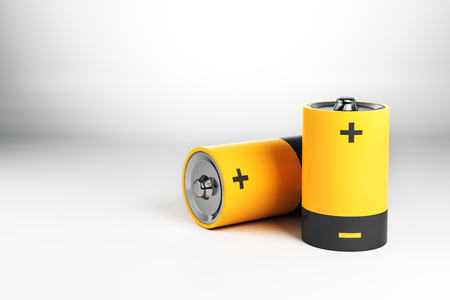 Abstract yellow battery on gray background. Energy concept. 3D Renderingの写真素材