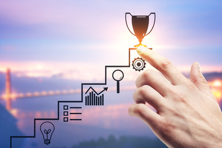 Hand pointing at creative ladder and award sketch on blurry city background. Leadership and career...