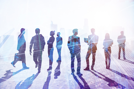 Teamwork, success and occupation concept. Businesspeople silhouettes on abstract city background with sunlight. Double exposureの写真素材