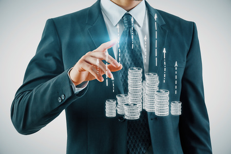 Double exposure with growth coins columns and man hand. Concept of success savings and capital.の写真素材