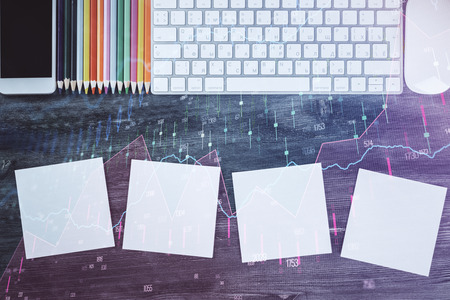Double exposure of stock market chart and office desktop on background. financial strategy concept.の写真素材