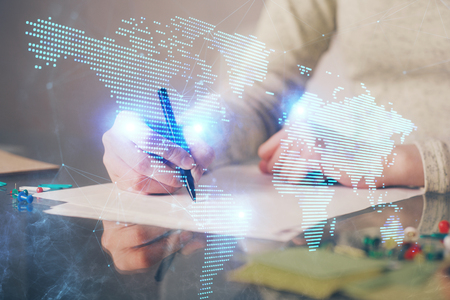 Social network theme hologram over hands taking notes background. Concept of global international people connect. Double exposureの写真素材