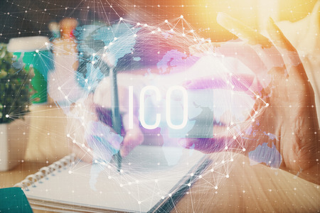 Cryptocurrency hologram over hands taking notes background. Concept of blockchain. Multi exposure