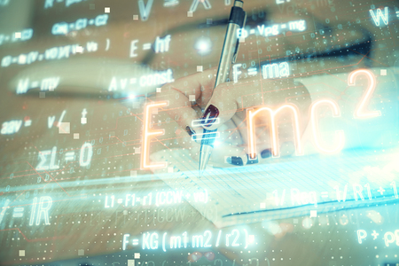 Science formula hologram over woman's hands taking notes background. Concept of study. Multi exposureの写真素材
