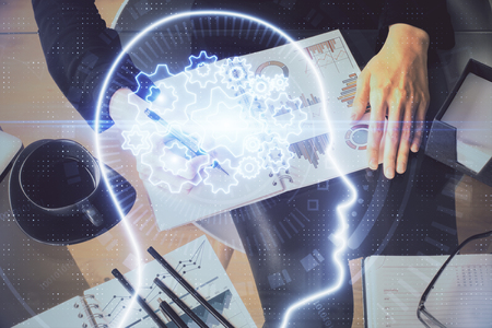 Multi exposure of woman's writing hand on background with brain hologram. Concept of brainstorming.の写真素材